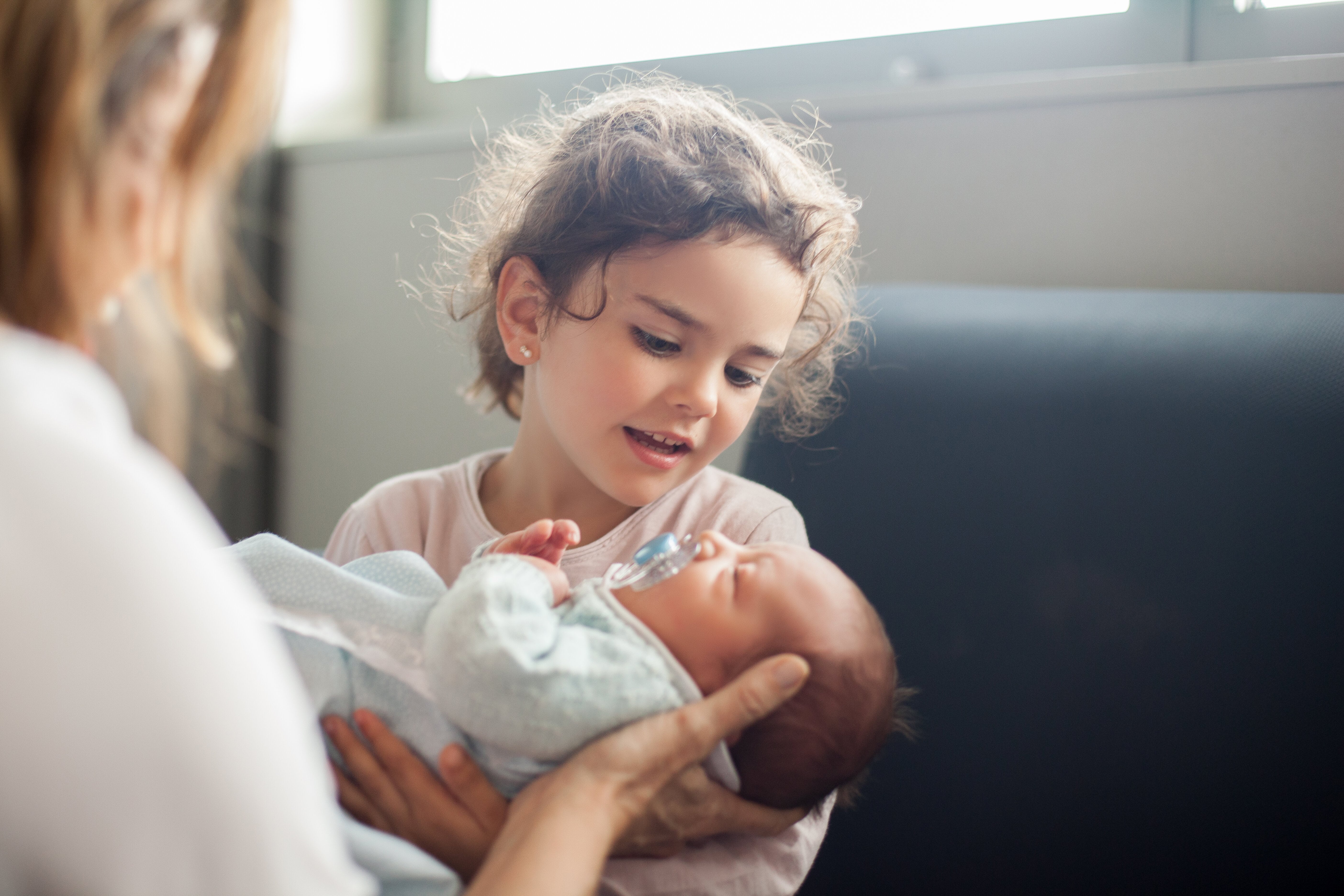Little girl holding new sibling