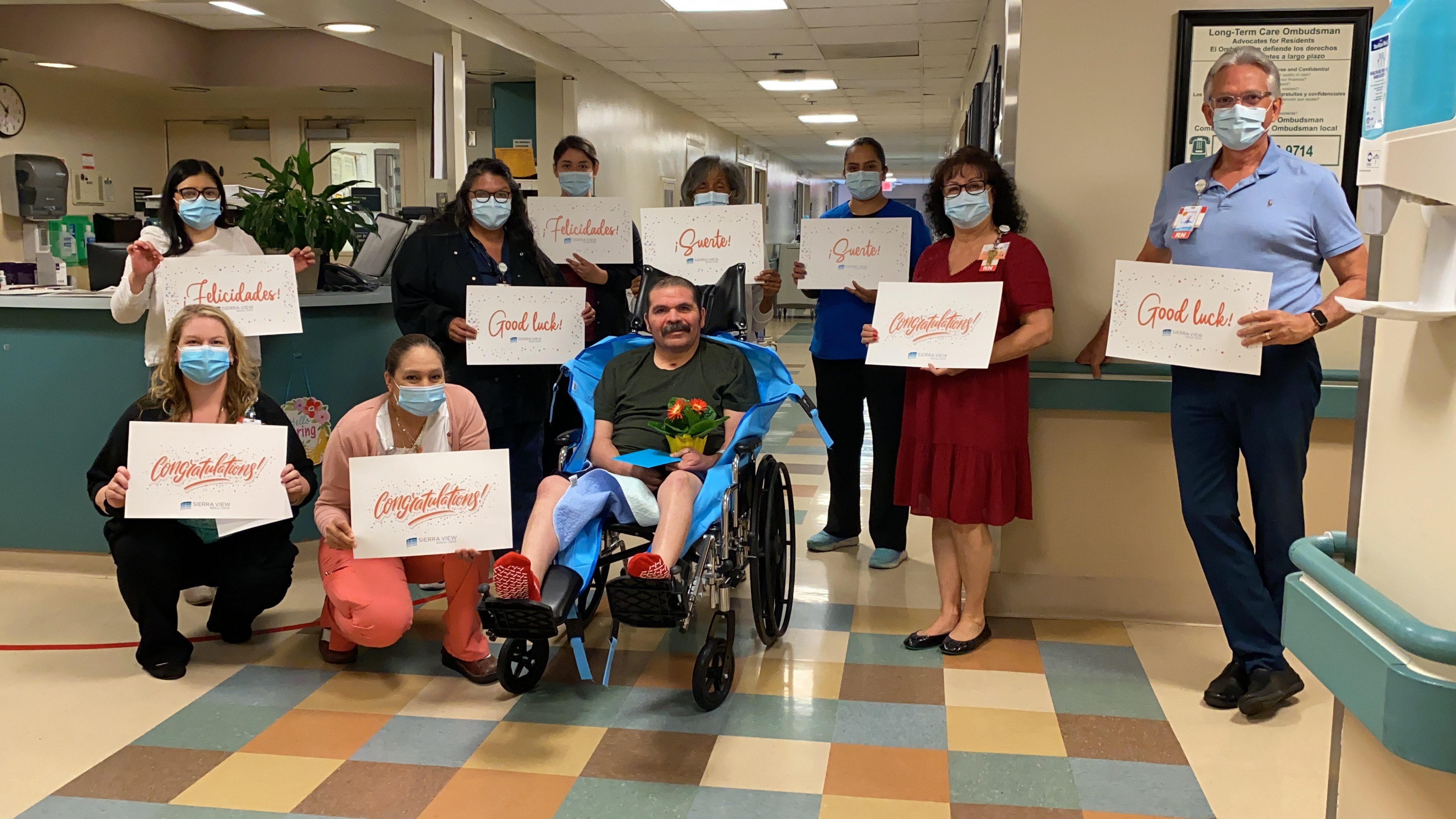 The DP/SNF Team celebrates Mr. Robert Torres' discharge. All staff took necessary COVID-19 precautions to briefly join Mr. Torres for a photo.