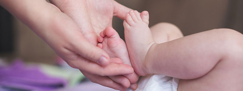 Mother holding baby's toes